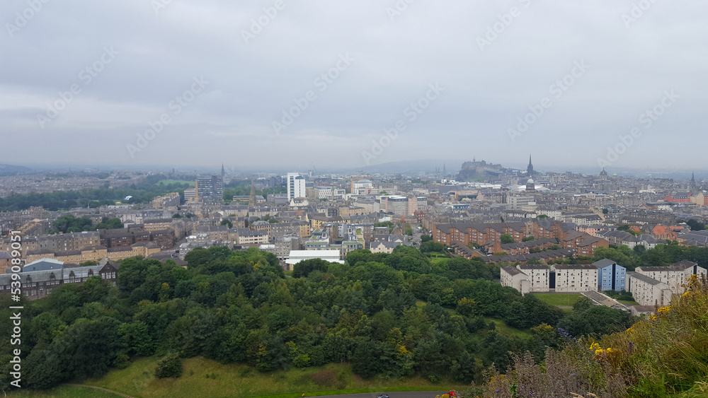 Panoramic landscape view of Edinburgh city with Georgian architecture houses, buildings and landmarks on atmospheric, grey and overcast day