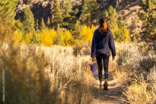 A woman hikes in the forest in the fall in Oregon