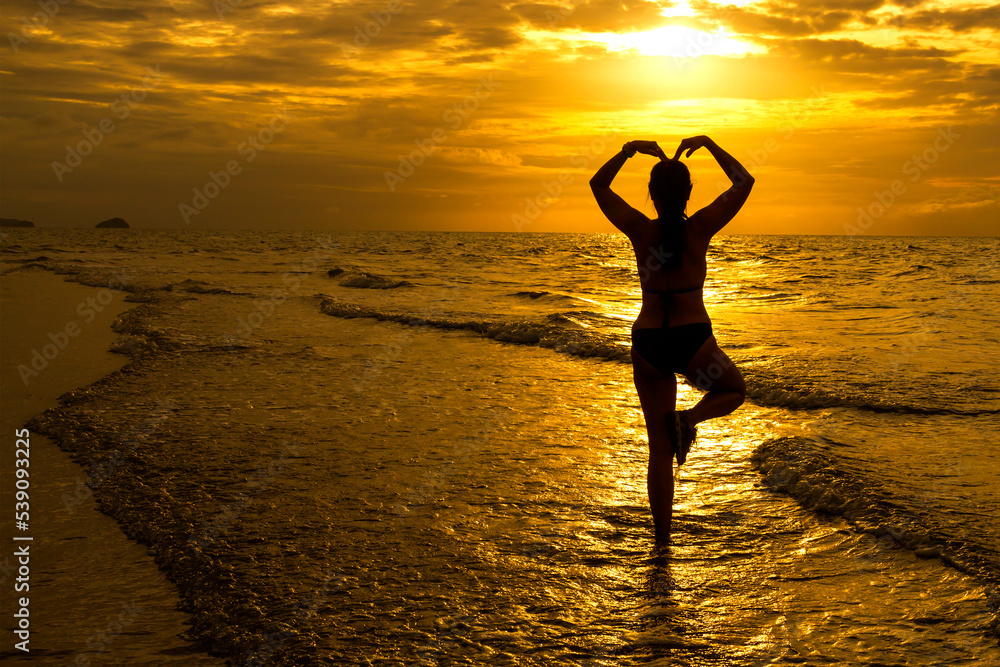 Woman with swimsuit  exercise andl with silhouette