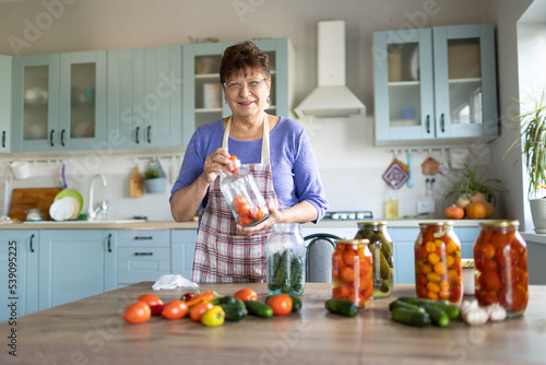 Woman in the kitchen canning vegetables