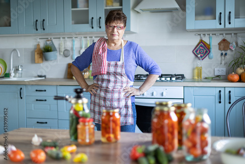 Woman in the kitchen canning vegetables