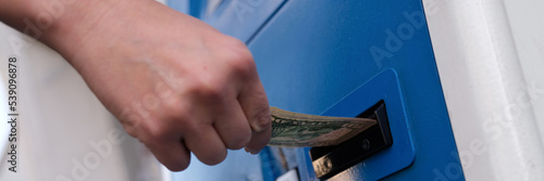 Replenishment of dollars in cash at ATM money in hand photo