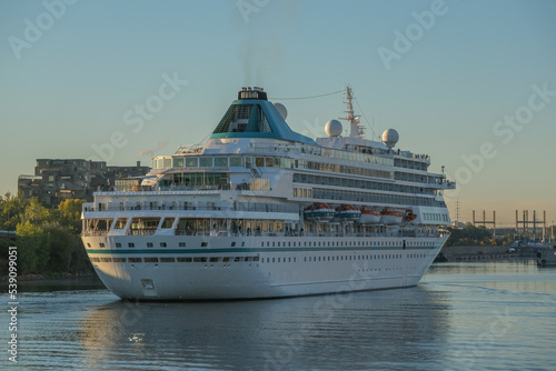 Fototapeta Naklejka Na Ścianę i Meble -  Phoenix cruiseship or cruise ship liner Amera in port of Montreal, Canada on sunny day on St. Lawrence River for Indian summer East Coast cruising with downtown skyline and terminal