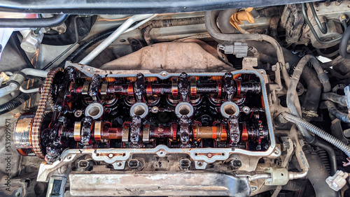 car engine that is being over houled caused by oil sludge, rocker arm, campshaft full of oil mud