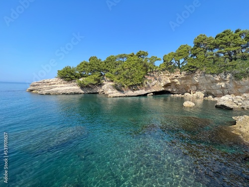 Turquoise sea bay of scenic rocky coast at summer sunny day.