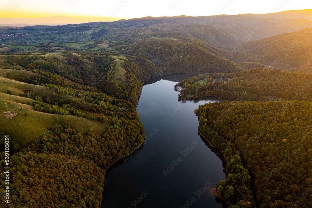 Colorful aerial view of Secu Lake in Caras-Severin - Romania, in the autumn, at sunrise. Scene captured from above, with a drone. Colorful aerial view of Secu Lake in Caras-Severin - Romania, in the autumn, at sunrise. Scene captured from above, with a drone.