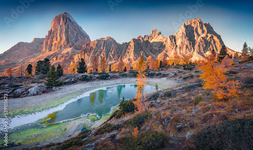 Superb morning view of frozen Limides lake. Spectacular autumn landscape of Dolomite Alps. Majestic outdoor scene of Falzarego pass, Italy, Europe. Beauty of nature concept background.