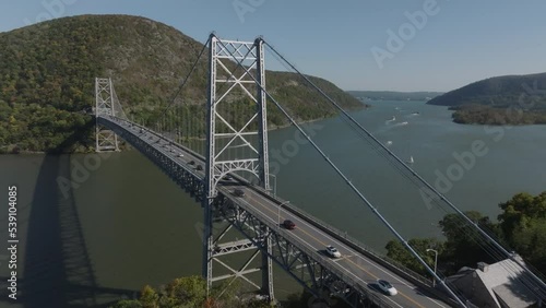 flying clockwise around and towards Bear Mountain Bridge over Hudson River in NY photo
