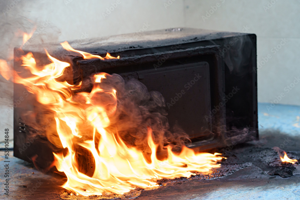 microwave oven on fire. the concept of fire in the kitchen and