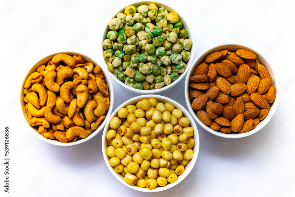 Grains in white bowl such as lotus seeds,almond,cashew and pea are producing plant,commercial grain crops are cereals and legumes.Grains well suited to industrial agriculture for milled,flour,oil. Grains in white bowl such as lotus seeds,almond,cashew and pea are producing plant,commercial grain crops are cereals and legumes.Grains well suited to industrial agriculture for milled,flour,oil.