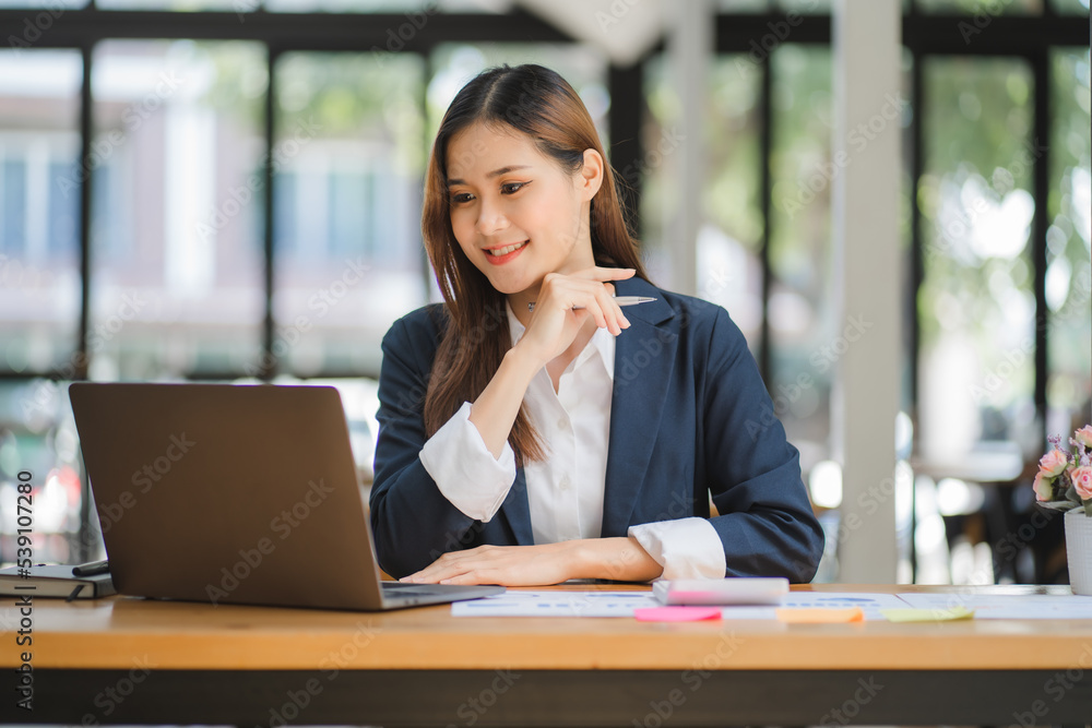 business woman or accountant who are using a calculator to calculate business data Accounting documents and laptop computer at the office business idea business woman or accountant who are using a calculator to calculate business data Accounting documents and laptop computer at the office business idea