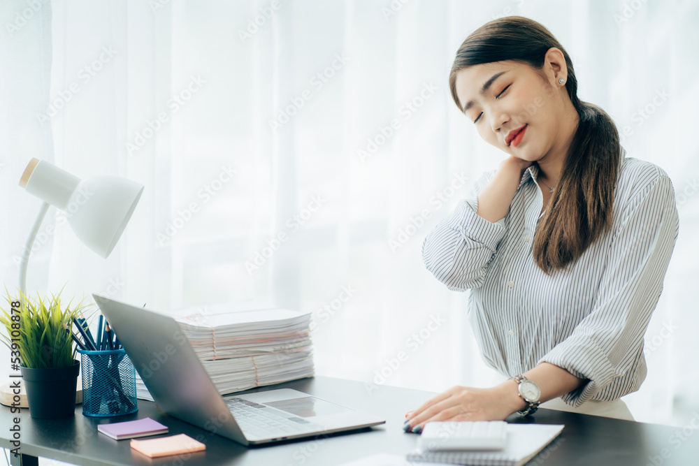 Portrait of smiling happy beautiful Asian woman relaxing using technology of laptop computer while sitting on table.Young creative girl working and typing on keyboard at cafe.work at home concept Portrait of smiling happy beautiful Asian woman relaxing using technology of laptop computer while sitting on table.Young creative girl working and typing on keyboard at cafe.work at home concept