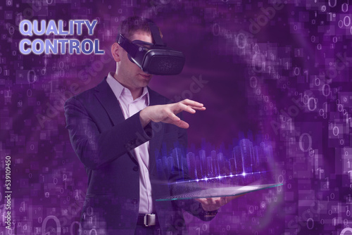 Business  Technology  Internet and network concept. Young businessman working on a virtual screen of the future and sees the inscription  Quality control