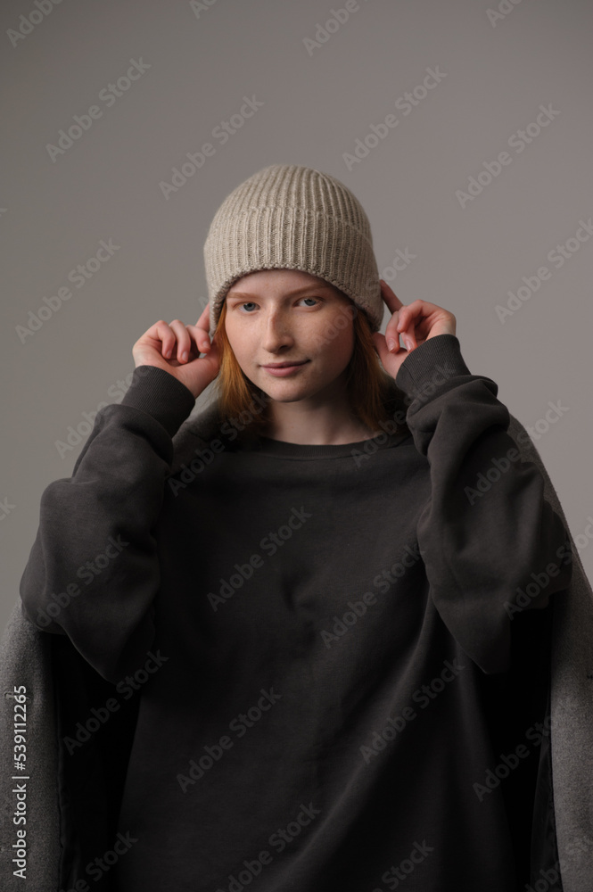 young girl model in beige hipster hat and coat isolated on light background. Product photo mockup for fashion brands and marketplaces, woolen cap, turkish textiles. young girl model in beige hipster hat and coat isolated on light background. Product photo mockup for fashion brands and marketplaces, woolen cap, turkish textiles.