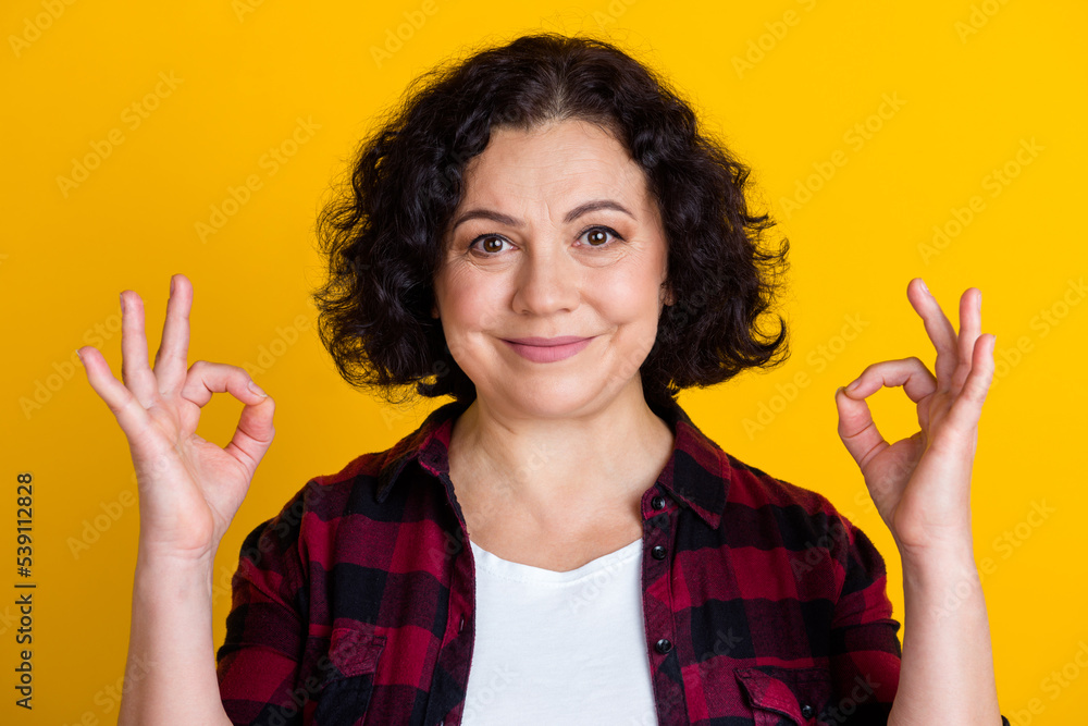 Photo of nice positive old woman show hand okay sign good mood isolated on vibrant color background Photo of nice positive old woman show hand okay sign good mood isolated on vibrant color background