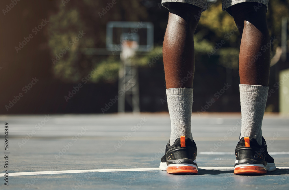 Fototapeta premium Basketball, sneakers and athlete black man standing on community sports court for match, motivation and streetball memory. Male player outside in USA with sport shoes on feet for fitness and exercise