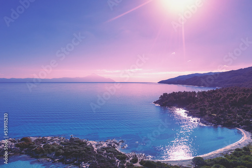 Mountain seascape on a sunny day, view from above. Rocky beach with beautiful bays. Vourvourou, Greece