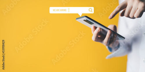 hand touch mobile job search with phone. find a job hire on business.advertisement yellow job search.looking resource.hiring job.