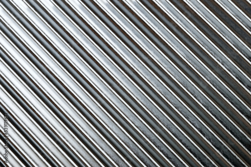 Texture of silver roof metal sheet. Metallic plate texture. Diagonal silver grey stripes wallpaper banner design. Corrugated metal plate background.