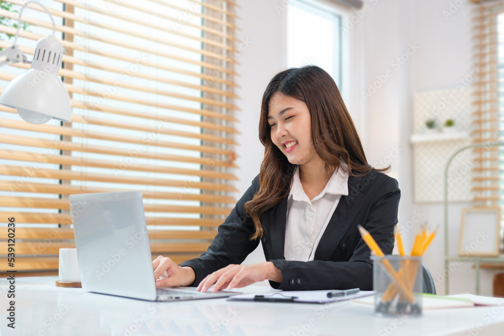 Smiling young businesswoman reading good news on laptop computer. Smiling young businesswoman reading good news on laptop computer.