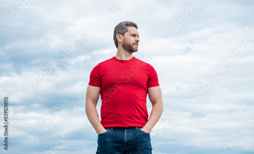 man model in red shirt outdoor on sky background