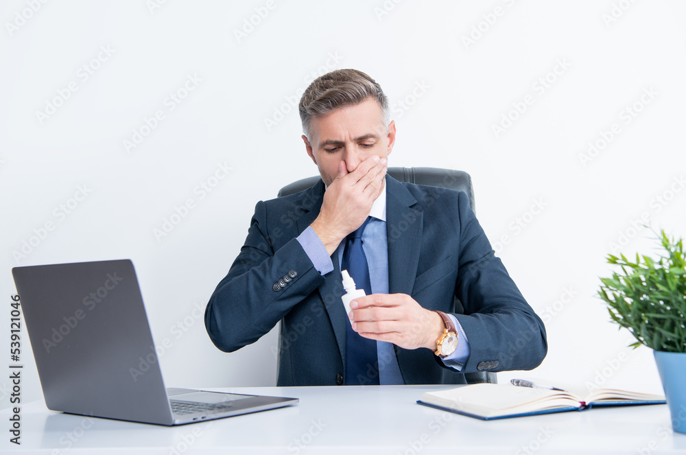 mature man in business office hold nasal drops mature man in business office hold nasal drops