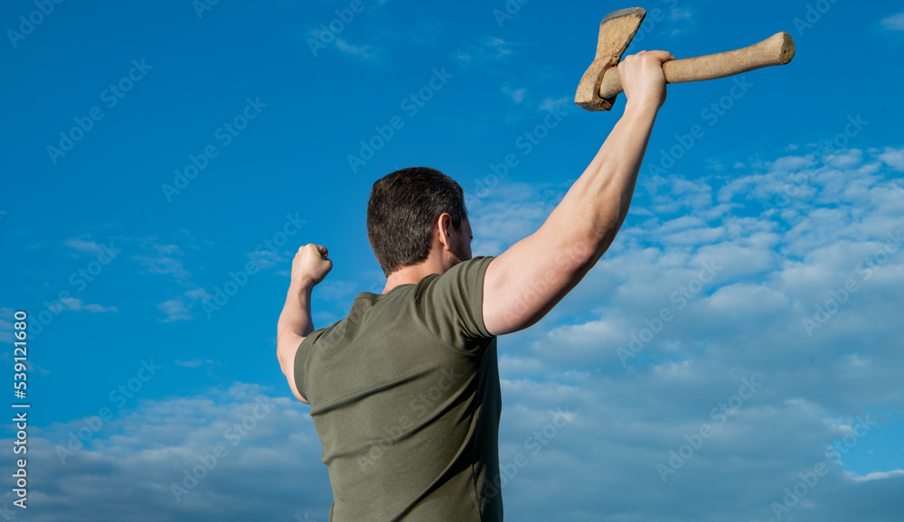 back view of free man with axe. man hold ax. brutal man on sky background back view of free man with axe. man hold ax. brutal man on sky background