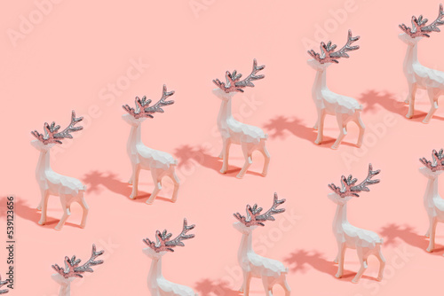 Whiter reindeers Christmas decorations on a candy pink background. Winter holidays inspired creative pattern.  © Biancaneve MoSt