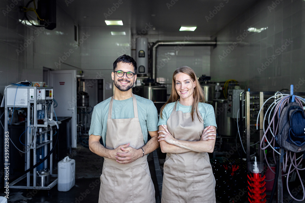 Portrait of two brewer in front of craft brewery. Portrait of two brewer in front of craft brewery.