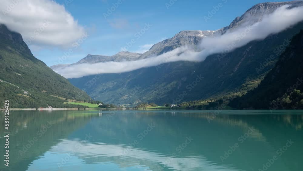 Timelapse video of moving clouds over Olden lake in Norway Timelapse video of moving clouds over Olden lake in Norway