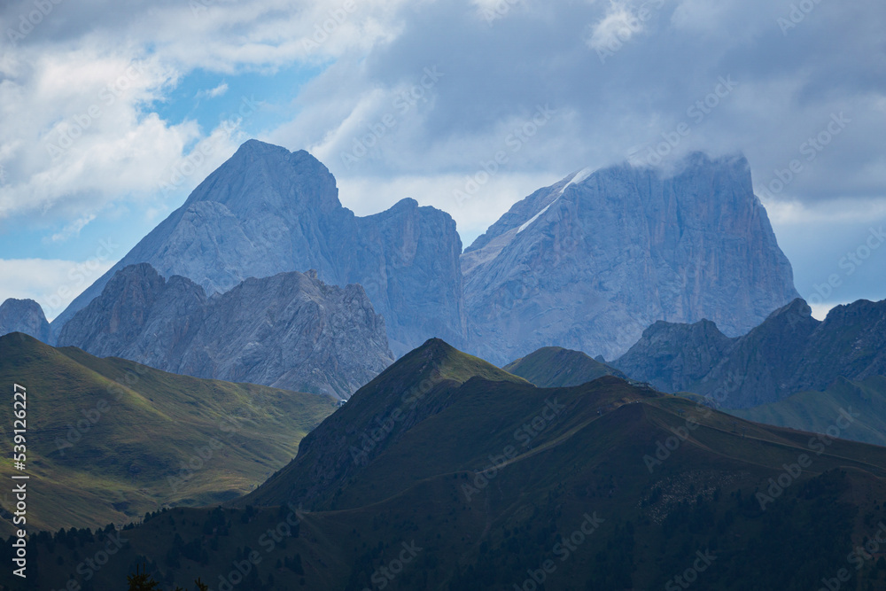 The landscape and the peaks of the Dolomites of the Val di Fassa, one of the most famous and touristic valleys of Trentino, near the town of Canazei, Italy - August 2022.