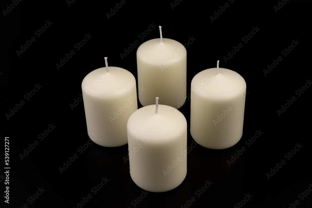 White candles on dark background. Close-up, copy space. White candles on dark background. Close-up, copy space.