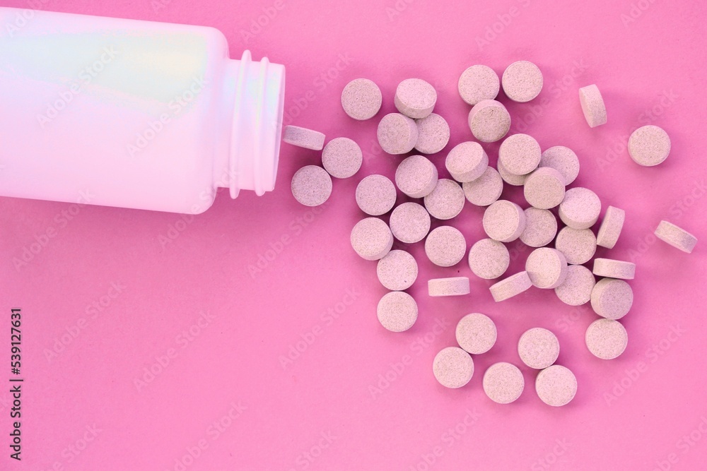 Tablets, capsule, pills and white plastic pack on pink background. Vitamin prescription supplement, drugs, Pharmaceutical medicine health therapy idea. Suicide abuse overdose concept. Doping steroid Tablets, capsule, pills and white plastic pack on pink background. Vitamin prescription supplement, drugs, Pharmaceutical medicine health therapy idea. Suicide abuse overdose concept. Doping steroid
