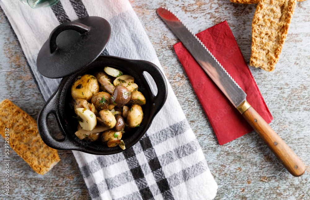 Mushrooms in garlic butter sauce. Stock Photo | Adobe Stock