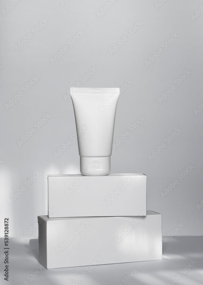 White cream tube mockup on square white boxes White cream tube mockup on square white boxes