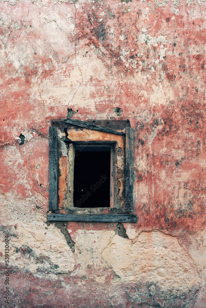 Pink weathered plaster wall with neglected small window. Pink weathered plaster wall with neglected small window.