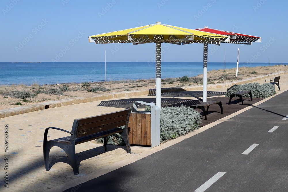 Umbrella in the city park near the sea.
