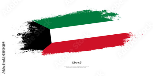 Happy Independence Day of Kuwait. National flag on artistic stain brush stroke background.
