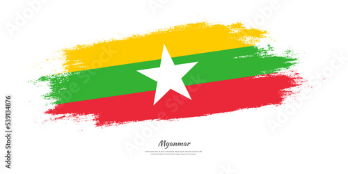 Happy Independence Day of Myanmar. National flag on artistic stain brush stroke background.