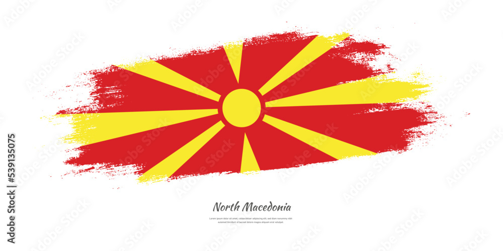 Happy Independence Day of North Macedonia. National flag on artistic stain brush stroke background.