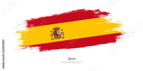 Happy Independence Day of Spain. National flag on artistic stain brush stroke background.