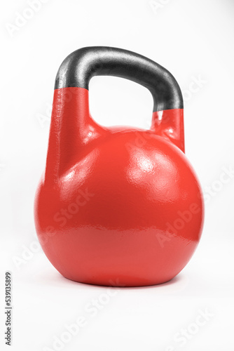 Classic red heavy cast iron kettlebell shot in a white studio.