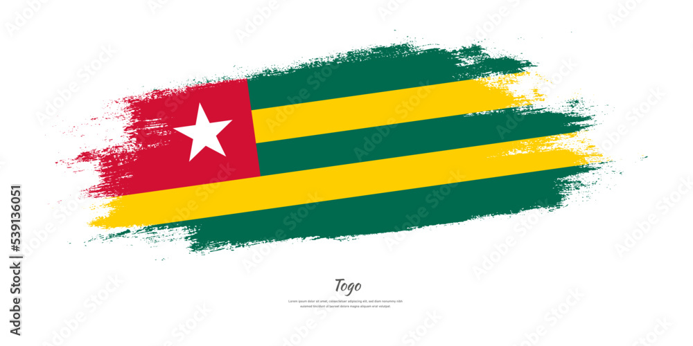 Obraz premium Happy Independence Day of Togo. National flag on artistic stain brush stroke background.