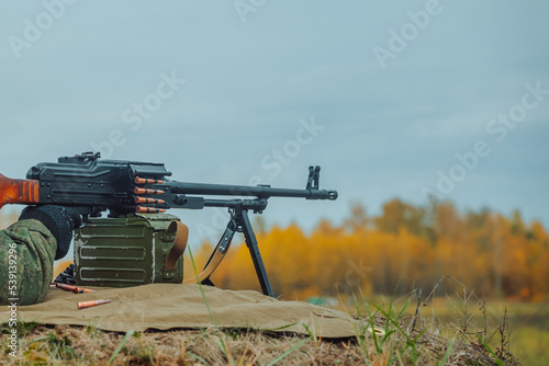 Machine gun automatic weapon, military equipment. Armed conflict, civil war. Machine Gun Shooting. photo