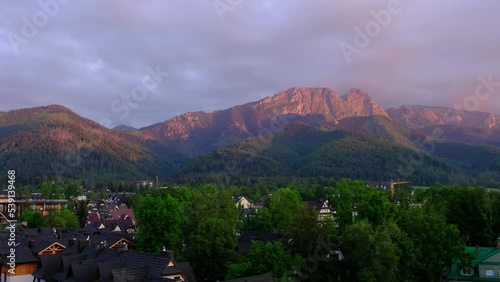 Landscape of the legendary Giewont peak in the Polish Tatry Mountains, farmland, forests near Zakopane, Poland, a resort town with traditional Goral architecture. View of Europe - Smooth 4K 24FPS photo