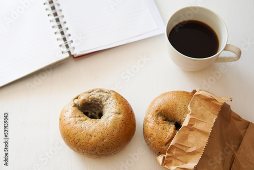 homemade bagel on white wood background.