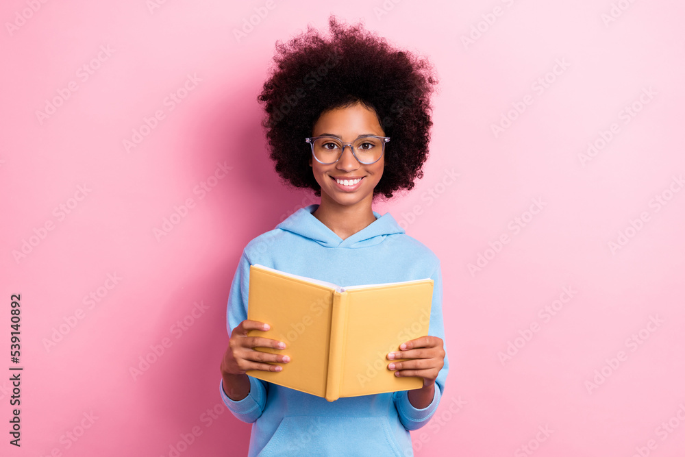 Photo portrait of adorable little girl spectacles hold opened book reading wear trendy blue outfit isolated on pink color background Photo portrait of adorable little girl spectacles hold opened book reading wear trendy blue outfit isolated on pink color background