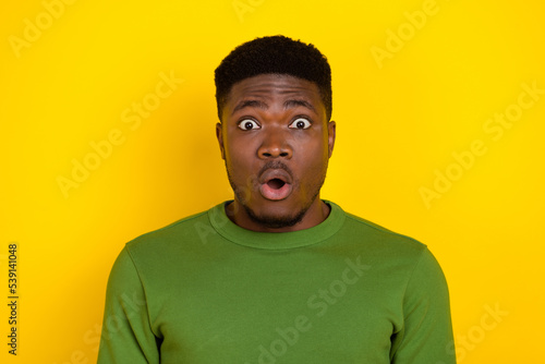 Portrait of attractive amazed worried brunet guy sudden news reaction isolated on bright yellow color background