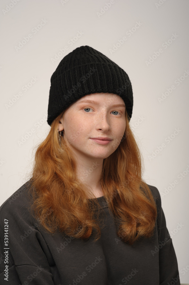 young girl model in black cap and grey jackett isolated on grey background. Product photo mockup for fashion brands and marketplaces. young girl model in black cap and grey jackett isolated on grey background. Product photo mockup for fashion brands and marketplaces.