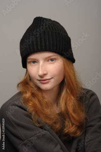 young girl model in black cap and grey jackett isolated on grey background. Product photo mockup for fashion brands and marketplaces. © Юрий Горид